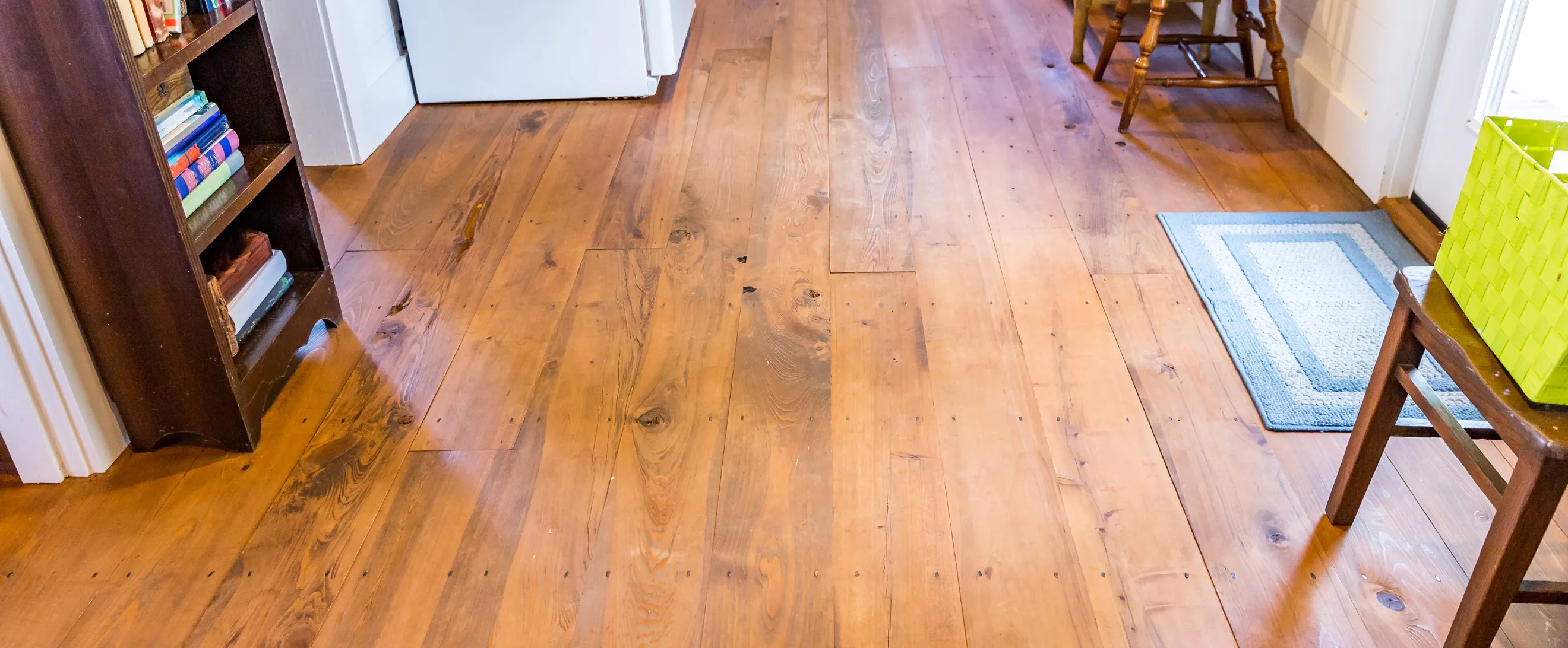 Worn wood flooring before renovation in Los Angeles with visible damage and discoloration