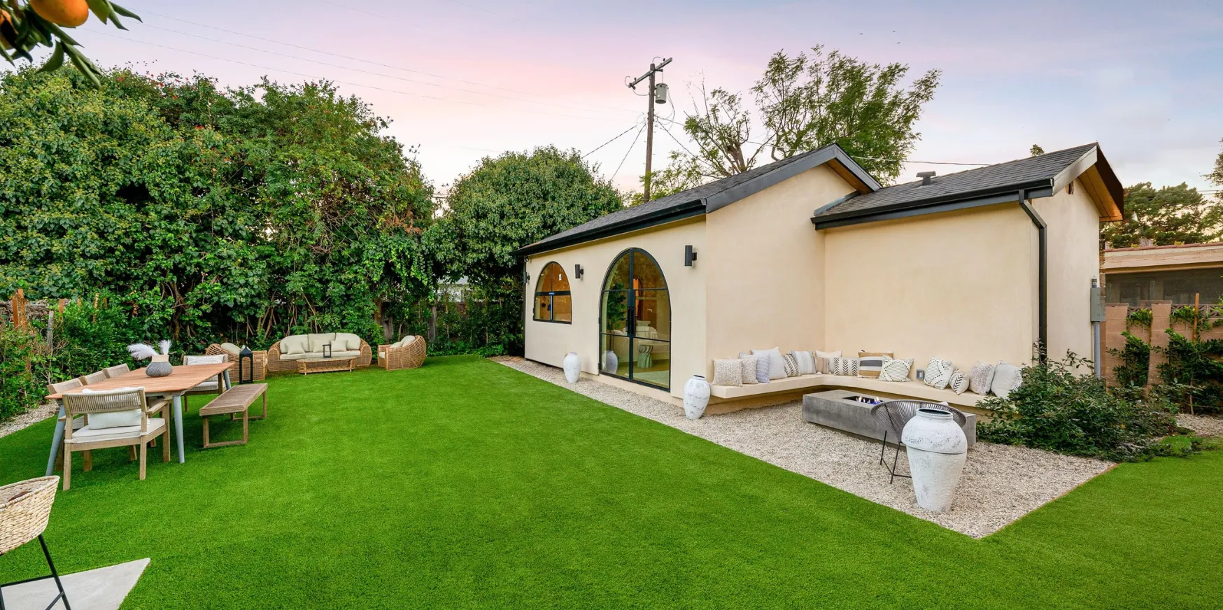 Detached ADU construction in Los Angeles backyard with modern design, outdoor seating area, and finished landscaping