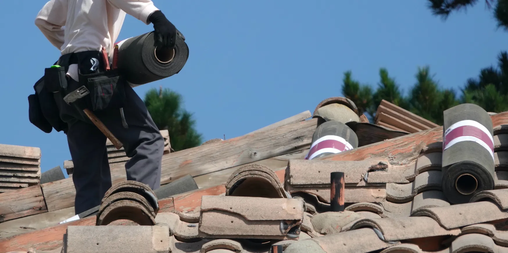 Roof replacement and installation in Los Angeles with new tiles being installed on residential home roof